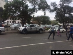 Vehicles with the ZANU-PF logo help break up protests against Zimbabwe's deteriorating economic conditions, in Harare, September 2017.