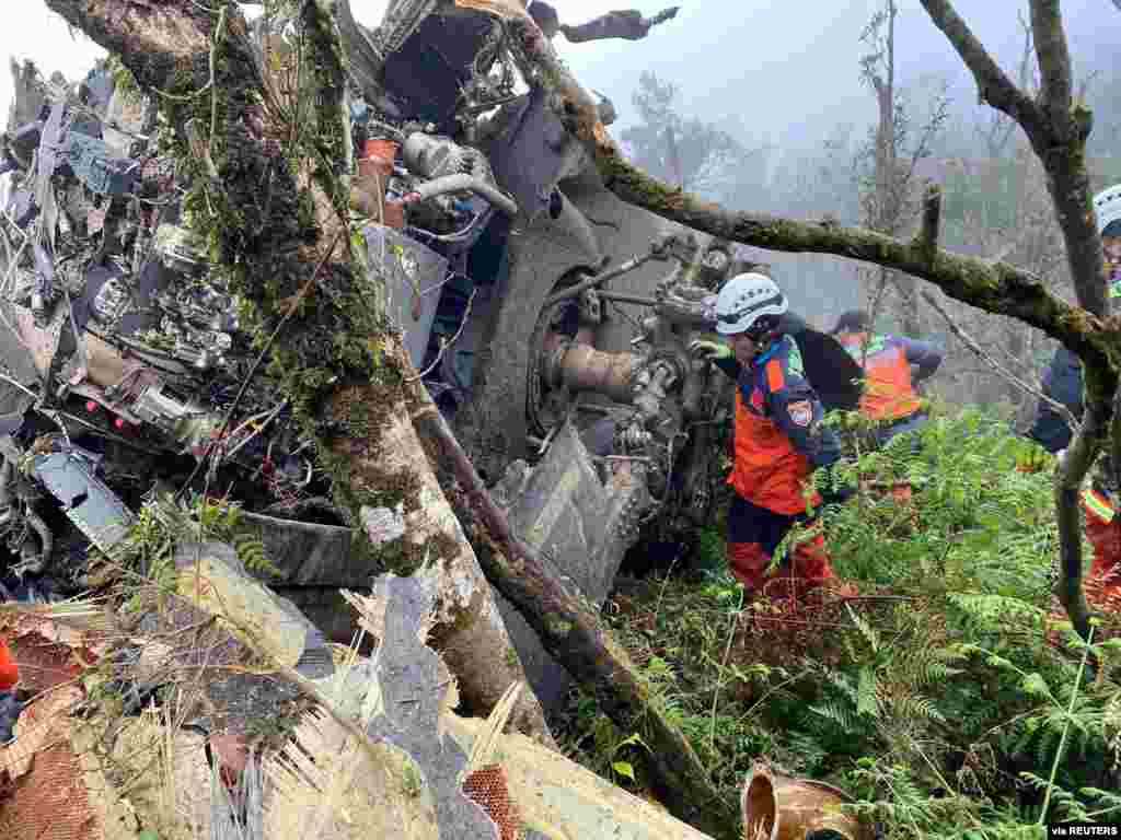 A rescue team searches for missing military officers after a Black Hawk helicopter made a forced landing at a mountainous area near Taipei, Taiwan.