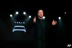 FILE - Tesla CEO Elon Musk speaks before unveiling the Model Y at Tesla's design studio in Hawthorne, California, March 14, 2019.