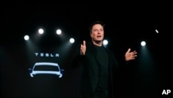 FILE - Tesla CEO Elon Musk speaks before unveiling the Model Y at Tesla's design studio in Hawthorne, California, March 14, 2019. 