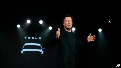 FILE - Tesla CEO Elon Musk speaks before unveiling the Model Y at Tesla's design studio in Hawthorne, California, March 14, 2019.