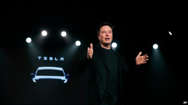 FILE - Tesla CEO Elon Musk speaks before unveiling the Model Y at Tesla's design studio in Hawthorne, California, March 14, 2019.