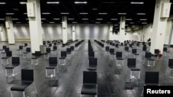 Empty chairs are seen at a makeshift COVID-19 vaccination site in Cologne, Germany, March 18, 2021.
