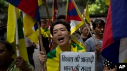 Exile Tibetans shout slogans during a protest to show support with India on Doklam standoff in New Delhi, India, Aug. 11, 2017.