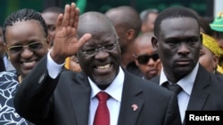 FILE - Tanzania's President elect John Magufuli salutes members of the ruling Chama Cha Mapinduzi Party (CCM) at the party's sub-head office on Lumumba road in Dar es Salaam.