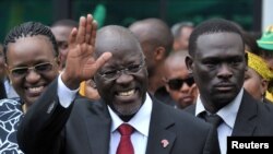 FILE - Tanzania's President elect John Magufuli salutes members of the ruling Chama Cha Mapinduzi Party (CCM) at the party's sub-head office on Lumumba road in Dar es Salaam.