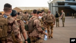 FILE - French Barkhane force soldiers who wrapped up a four-month tour of duty in the Sahel leave their base in Gao, Mali, June 9, 2021. 