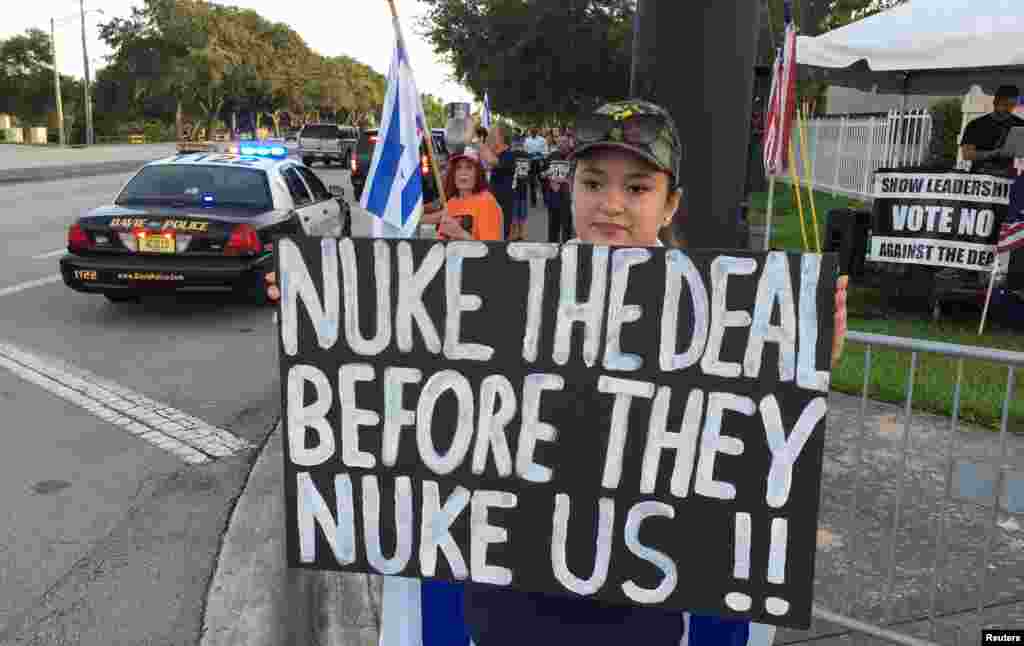 Protester Kayla Marks of Hollywood, FLorida, holds a sign before U.S. Vice President Joe Biden met with Jewish community leaders at the David Posnack Jewish Community Center in Davie, Florida, USA. Biden tried to reassure Jewish leaders in south Florida that President Barack Obama's nuclear deal with Iran would be a vital step toward making the world a safer place.