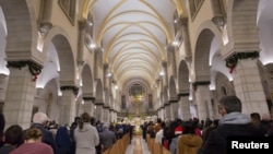 The acting Latin Patriarch of Jerusalem Pierbattista Pizzaballa leads a Christmas midnight mass at Saint Catherine's Church, in the Church of the Nativity, in Bethlehem, in the Israeli-occupied West Bank, Dec. 25, 2018.