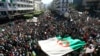 Algerians march with a giant national flag during a protest in Algiers, Algeria, March 15, 2019. Tens of thousands of people gathered Friday in Algeria's capital and other cities for what could be decisive protests against longtime leader Abdelaziz Bouteflika.
