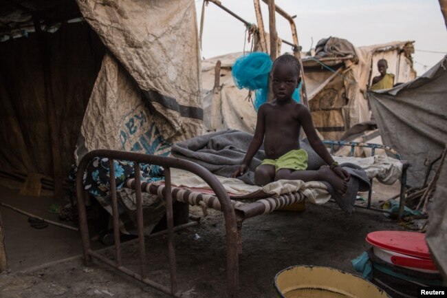 A photo taken on March 13, 2018, shows a child siting on a bed at an internally displaced person camp, hosting more than 24,000 people, in Malakal, South Sudan.
