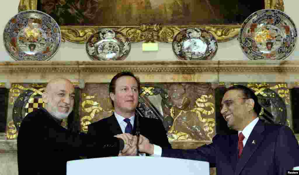 Britain's Prime Minister David Cameron shakes hands with Afghan President Hamid Karzai and Pakistan's President Asif Ali Zardari, at Cameron's country residence, Chequers, west of London, February 4, 2013. 