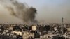 Smoke billows over buildings following an Israeli bombardment in Rafah, Gaza Strip, on March 27, 2024. The White House announced on March 28 that Israel's plans for a ground invasion of the city are on hold for now.