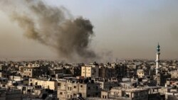 Smoke billows over buildings following an Israeli bombardment in Rafah, Gaza Strip, on March 27, 2024. The White House announced on March 28 that Israel's plans for a ground invasion of the city are on hold for now.