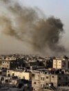 Smoke billows over buildings following an Israeli bombardment in Rafah, Gaza Strip, on March 27, 2024. The White House announced on March 28 that Israel's plans for a ground invasion of the city are on hold for now.