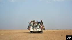 FILE - Nigeriens and migrants head toward Libya from Agadez, Niger, June 4, 2018.