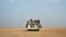 FILE - Nigeriens and third-country migrants head toward Libya from Agadez, Niger, June 4, 2018.