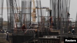 Laborers work at a construction site in Phnom Penh. Cambodia's economy is projected to expand by 7.3 percent in 2015, up from 7 percent in 2014, and will climb to 7.5 percent next year, Asian Development Bank (ADB) said in its Asian Development Outlook 20