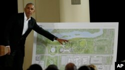FILE - Former President Barack Obama points to a rendering of his lakefront presidential center at a community event at the South Shore Cultural Center in Chicago, Illinois, May 3, 2017. 