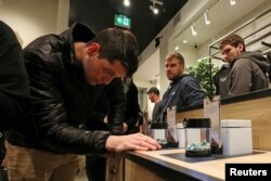 A customer looks at cannabis on display after legal recreational marijuana went on sale at a Tweed retail store in St John's, Newfoundland and Labrador, Canada, Oct. 17, 2018.