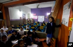 A student shares information with her classmates regarding awareness about rape and kidnap attempts at a school in Kasur, Jan. 19, 2018.