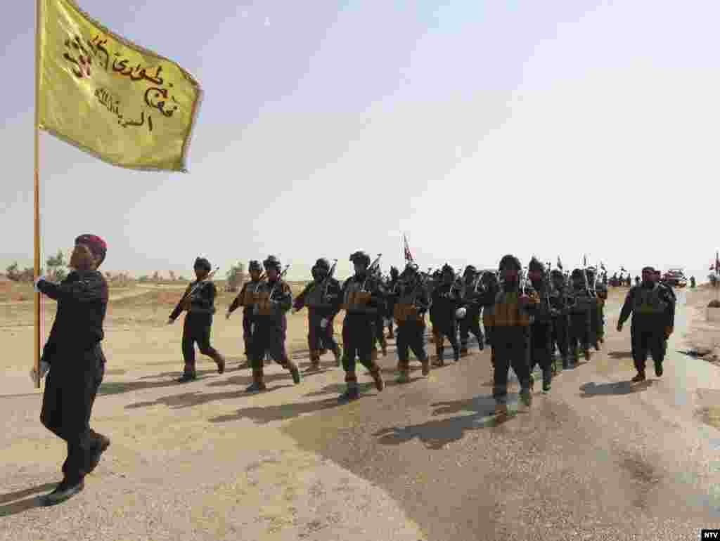 Iraqi special police officers march during a graduation ceremony in Karbala, Aug. 28, 2014. 