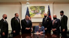 Republican Governor Brian Kemp signs the law S.B. 202, a restrictive voting law that activists have said aimed to curtail the influence of Black voters who were instrumental in state elections that helped Democrats win the White House