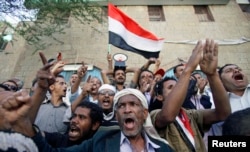 Protesters shout slogans against the Shi'ite Muslim Houthi movement, in the southwestern city of Taiz, Yemen, Feb. 16, 2015.