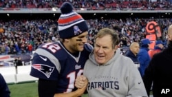 New England Patriots quarterback Tom Brady, left, celebrates with head coach Bill Belichick after winning a football game, Dec. 14, 2014, in Foxborough, Mass.