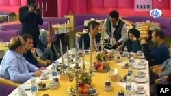 An image grab taken from footage broadcast by Iran's state-run Arabic-language Al-Alam satellite news channel without the permission of the German detainees, shows what the TV said was images of the meeting between German journalists detained in Iran sinc