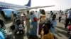 Ethnic South Sudanese board a plane to fly home at Sudan's Khartoum airport, May 14, 2012.