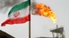 FILE - A gas flare on an oil production platform in the Soroush oil fields is seen alongside an Iranian flag in the Persian Gulf, Iran, July 25, 2005.