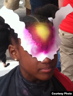 At the face painting booth, kids at the Ultimate Science Street Fair were able to choose science-based motifs such as galaxies, cells, and butterfly heads (shown here) (A. Phillips/VOA)