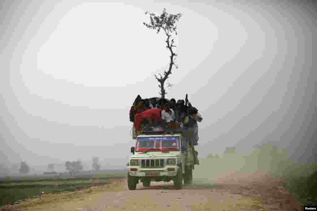 An overloaded vehicle transports people returning from the "Gadhimai Mela" festival held in Bariyapur, Nov. 29, 2014. Sword-wielding Hindu devotees in Nepal began slaughtering thousands of animals and birds in a ritual sacrifice, ignoring calls by animal rights activists to halt what they described as the world's largest such exercise.