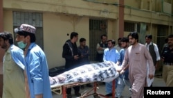Hospital workers push a stretcher carrying the body of a policeman who was one of the policemen shot dead in Quetta, Pakistan, July 13, 2017.