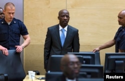 FILE - Charles Ble Goude of Ivory Coast enters the courtroom of the International Criminal Court (ICC) for his initial appearance in The Hague, Netherlands, March 27, 2014.