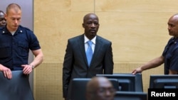 Charles Ble Goude of Ivory Coast enters the courtroom of the International Criminal Court (ICC) for his initial appearance in The Hague, Netherlands, March 27, 2014.