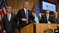 Mayor Bill deBlasio, second from left, along with Police Commissioner James O'Neil, far left, FBI Assistant Director William Sweeney, second from right, and NYPD Deputy Commissioner of Intelligence and Counterterrorism John Miller, far right, hold a news conference on the latest in the package bomb investigation, Thursday Oct. 25, 2018, in New York.