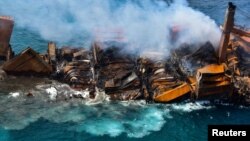 Asap mengepul dari kapal kargo "MV X-Press Pearl" yang membawa berton-ton bahan kimia dan memicu bencana lingkungan, saat kapal itu tenggelam di Pelabuhan Colombo, Sri Lanka, Rabu 2 Juni 2021.(Foto: Sri Lanka Airforce Media via Reuters)