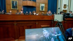 Chairman of the Joint Chiefs of Staff Gen. Mark Milley appears on a screen as he testifies before the House Armed Services Committee on the conclusion of military operations in Afghanistan on Capitol Hill in Washington, Sept. 29, 2021.