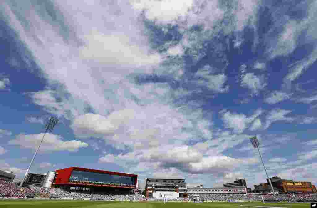 Dramatic clouds hang overhead as England plays Australia during day two of the third Ashes Test match held at Old Trafford cricket ground in Manchester, England. 
