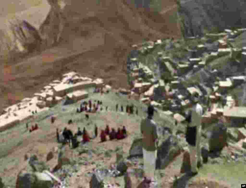 This image made from AP video shows people searching for survivors after a massive landslide landslide buried a village in Badakhshan province, northeastern Afghanistan, May 2, 2014. 