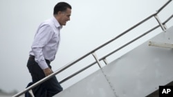 Republican presidential candidate Mitt Romney boards his campaign plane, October 9, 2012, in Newport News, Virginia.