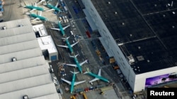 FILE - An aerial photo shows Boeing 737 Max airplanes parked on the tarmac at the Boeing factory in Renton, Wash., March 21, 2019.