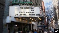 Patrons wait to see "The Interview" at the Cinema Village movie theater in New York, Dec. 25, 2014.