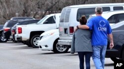 Family members escort their children out of North Marshall Middle School in Kentucky, Jan. 23, 2018, after the students where transported from Marshall High School.