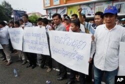 Pro-ruling party demonstrators stage a protest rally in front of National Assembly in Phnom Penh, Cambodia, Monday, Oct. 26, 2015.