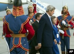 FILE - U.S. Ambassador to Mongolia Jennifer Zimdahl Galt and U.S. Secretary of State John Kerry past a traditional honor guard upon arrival at Chinggis Khaan International Airport in Ulaanbaatar, Mongolia, June 5, 2016.