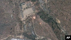 Satellite image provided by GeoEye appears to show a train of mining carts, at the lower center of the frame, and other preparations underway at North Korea's Punggye-ri nuclear test site, April 18, 2012.
