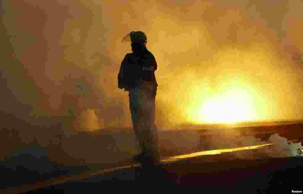 A policeman stands amidst thick smoke from flares during a Europa League Group soccer match between CSKA Sofia and Besiktas in Sofia December 2, 2010. (Oleg Popov/Reuters)